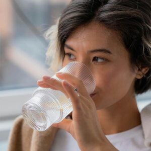 woman drinking a glass of water